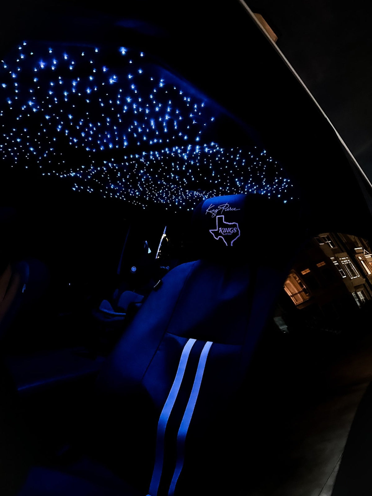 Starlight headliner installed in a truck cab at night with the fiber optic stars lit blue over the seats